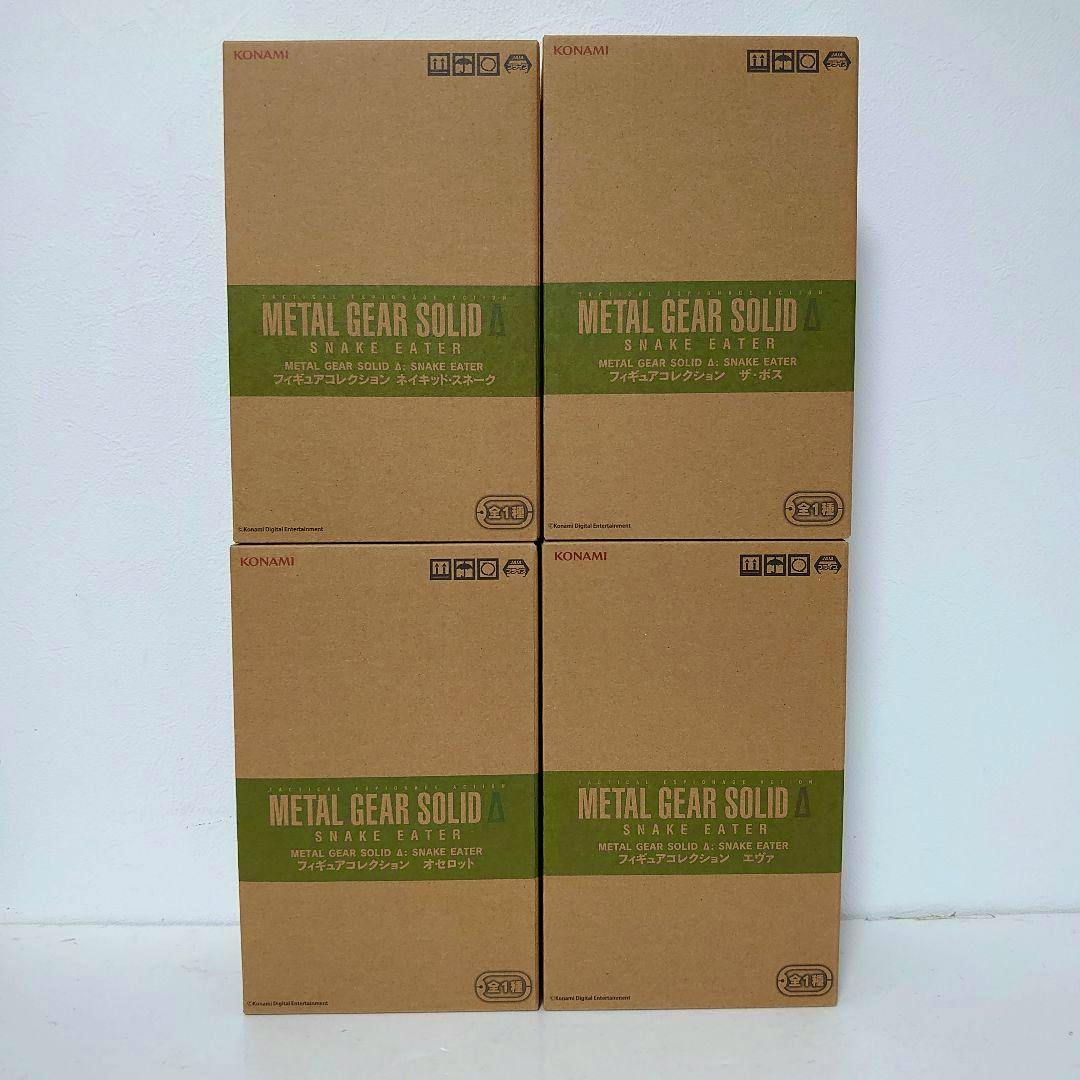Four cardboard boxes of METAL GEAR SOLID Δ Snake Eater figure packages arranged in a 2-by-2 grid against a white background.
