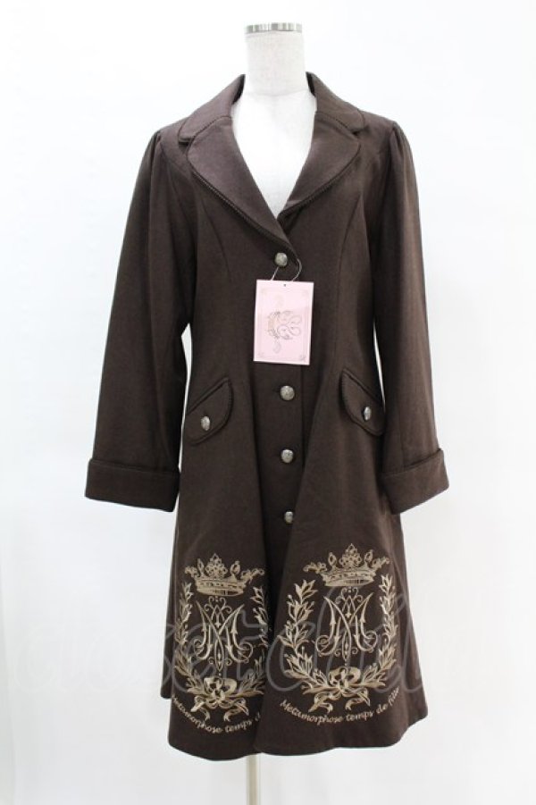 Front view of a brown women's wool coat with crown emblem embroidery on the hem displayed on a mannequin.