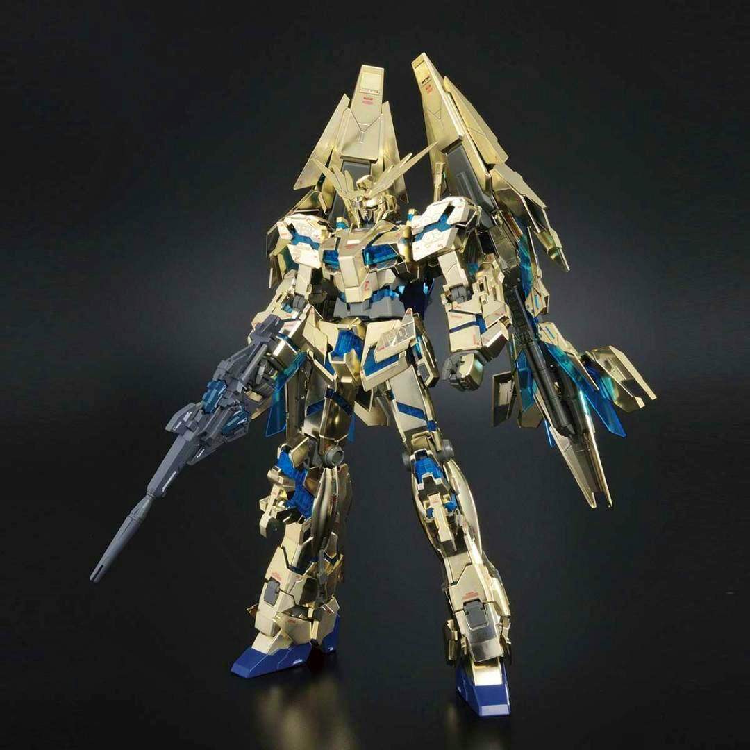 Assembled gold MG Unicorn Gundam 3rd unit Phenex model kit posed against a dark background.