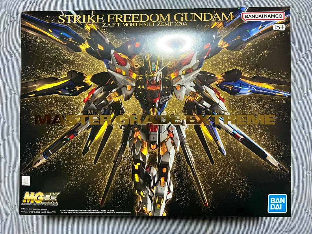 Front photo of the MGEX Strike Freedom Gundam model kit box showing the box art and Bandai/Bandai Namco logos.