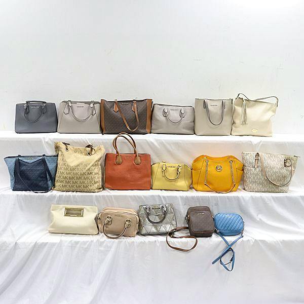 A set of 17 Michael Kors bags and purses arranged on three tiers against a white background.