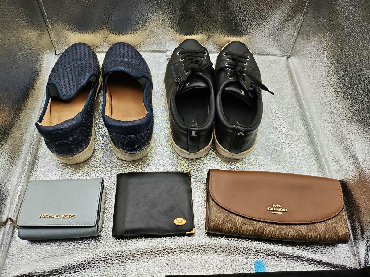 A light blue MICHAEL KORS wallet at bottom left shown with two other wallets and two pairs of shoes.