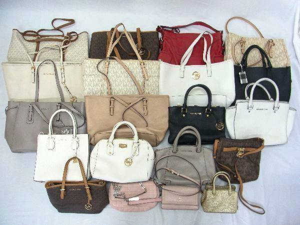 Multiple Michael Kors handbags and shoulder bags arranged on a white background.