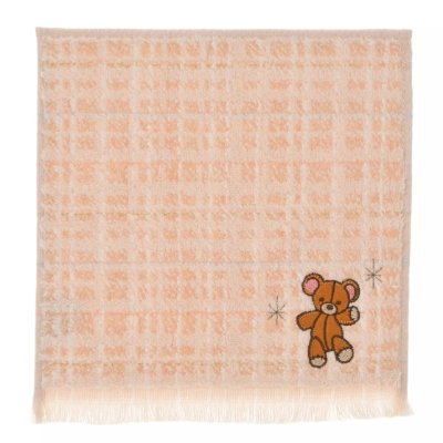 Peach tweed-style mini towel with a small embroidered teddy bear in the lower corner.