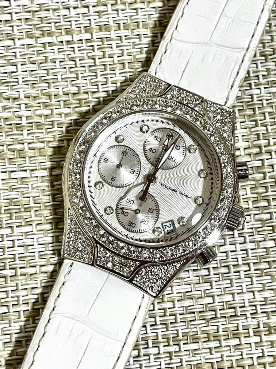Silver chronograph wristwatch with pavé crystal bezel, white strap, three subdials and a date window.