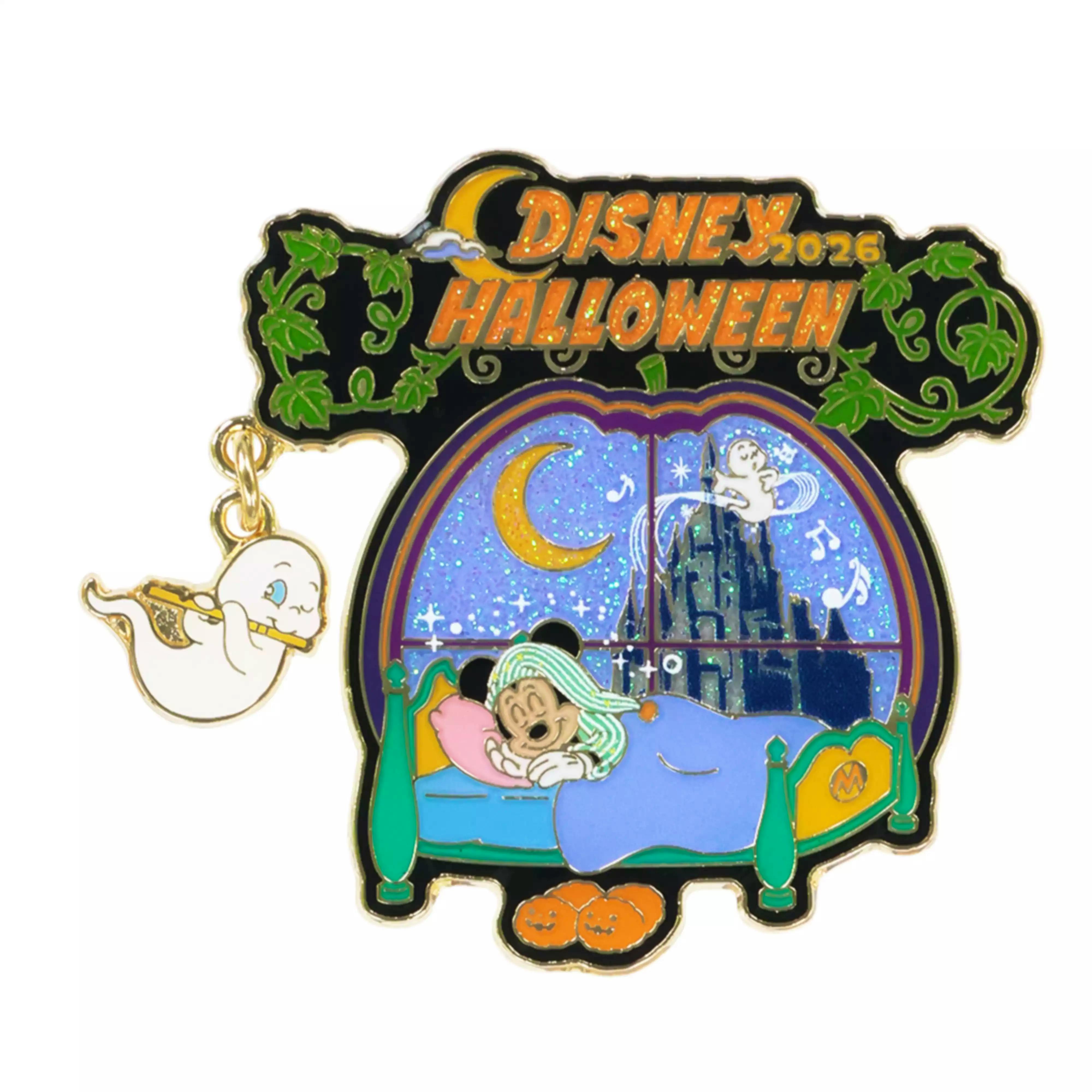 Close-up of a Disney Halloween metal pin badge showing sleeping Mickey in a bed, a glittery moon window scene, a small ghost charm, and the text "DISNEY HALLOWEEN".