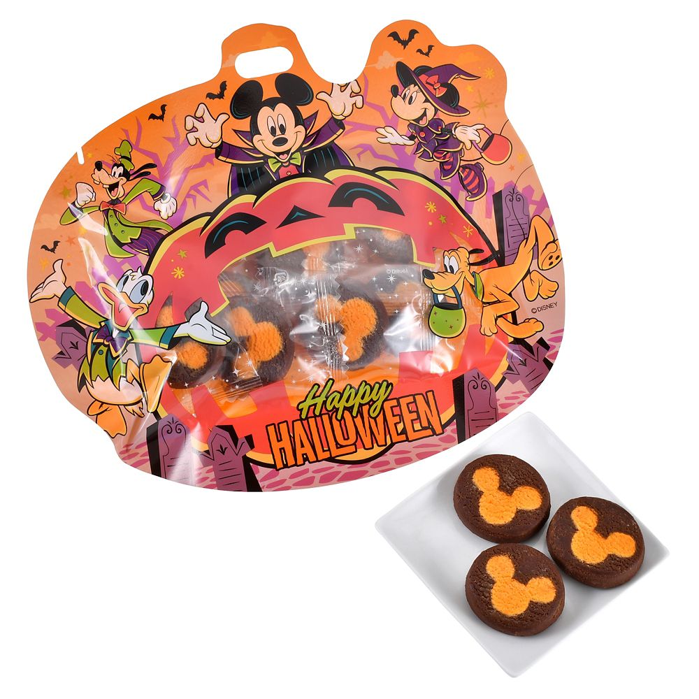Halloween-themed pumpkin-shaped Disney package with Mickey & Friends artwork and a plate showing three round chocolate cookies decorated with an orange Mickey head pattern.