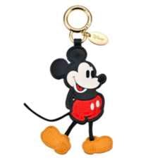 Plastic Mickey Mouse keychain showing a full-body figure with red shorts, yellow shoes, and a gold keyring.
