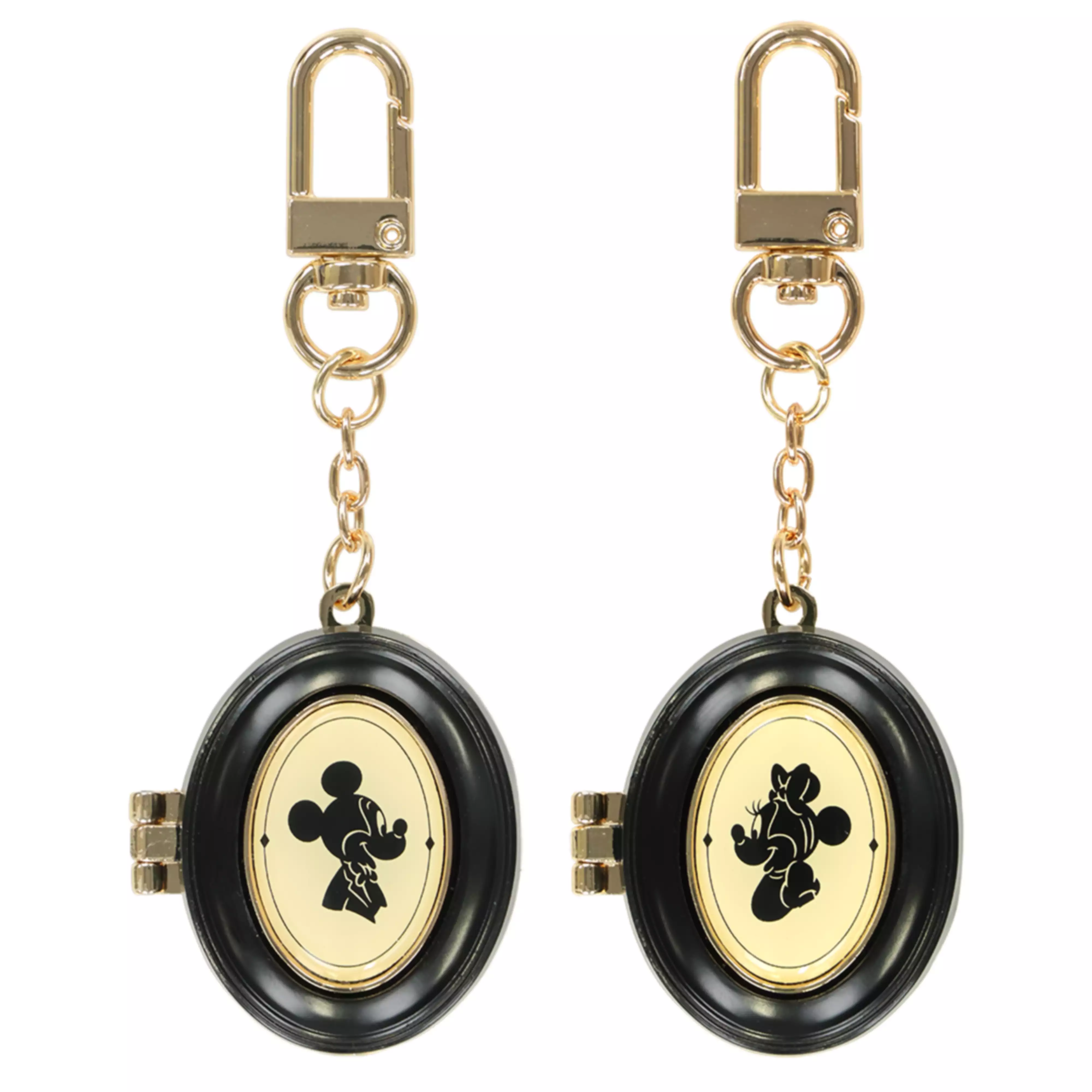 Two oval black and gold keychains featuring Mickey and Minnie silhouette motifs with gold chain and clasp.