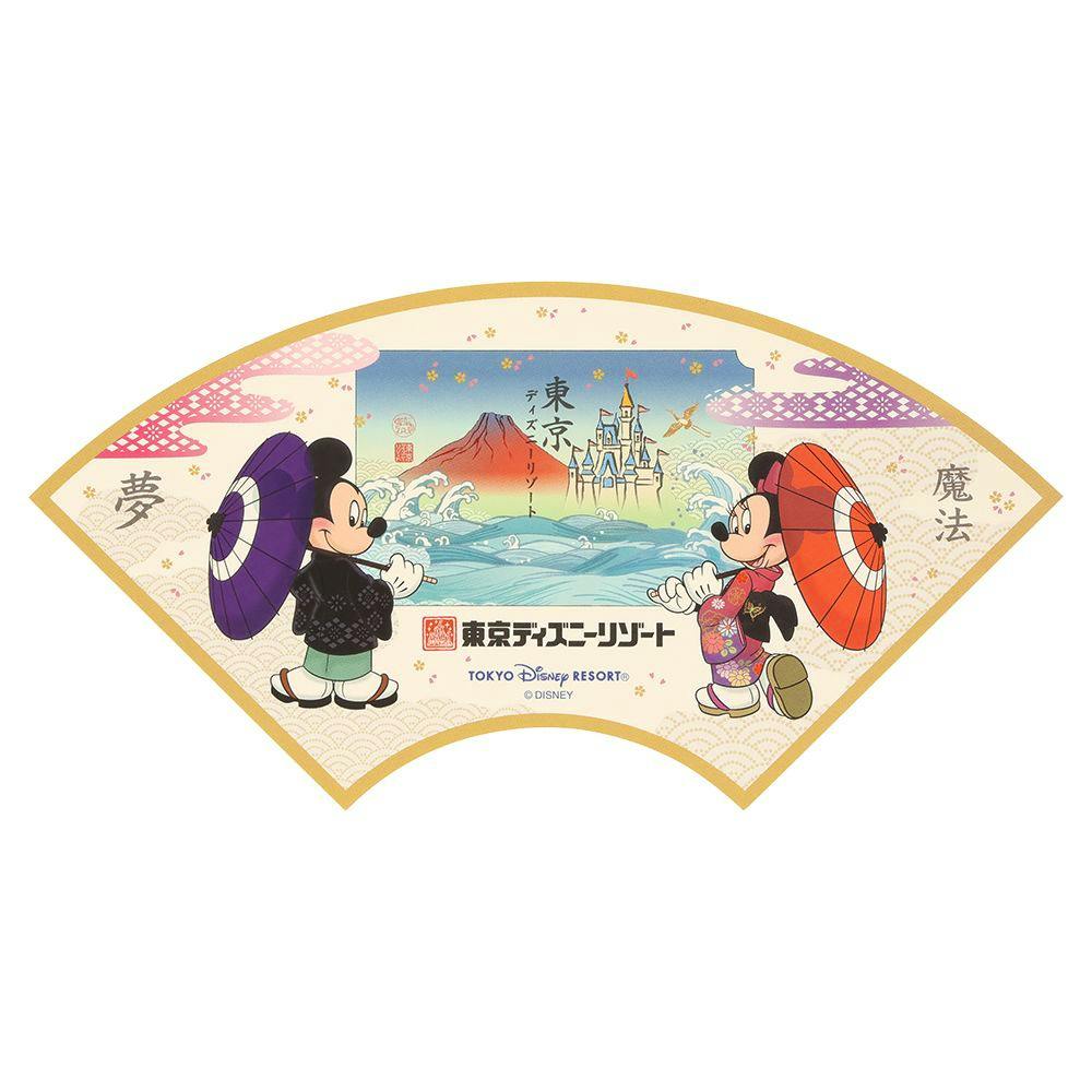 Fan-shaped paper sticker depicting Mickey and Minnie in traditional Japanese clothing with umbrellas and Tokyo Disney Resort artwork including a castle and Mount Fuji.