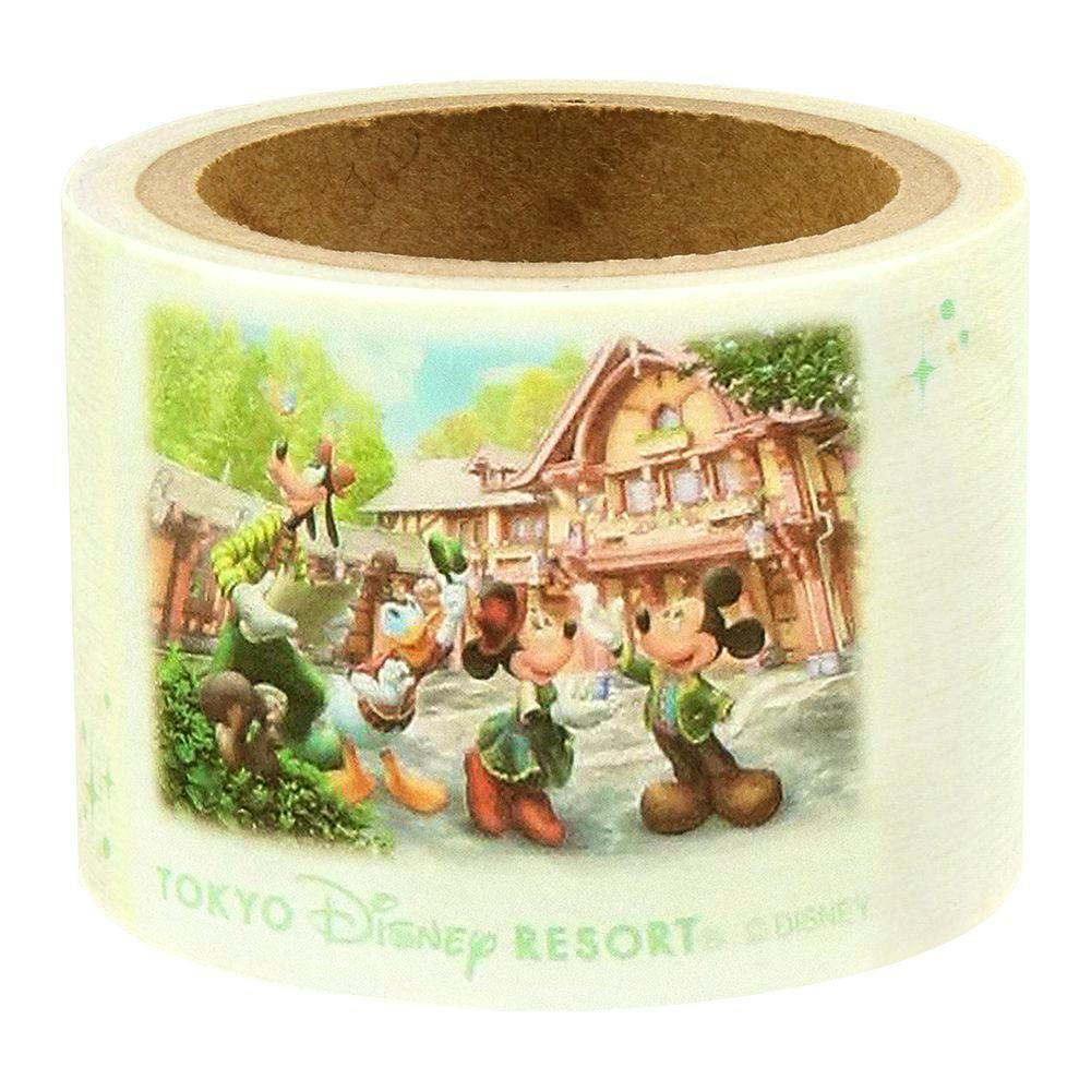 A roll of masking tape printed with Mickey Mouse, Donald Duck, and Goofy in front of a Tokyo Disney Resort building.