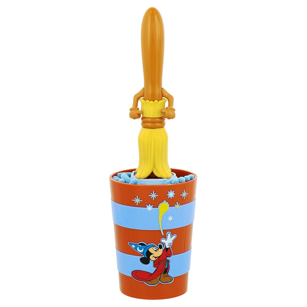 A Mickey Mouse-themed dustpan and brush set with a yellow brush handle standing in an orange and blue striped cup featuring Mickey.