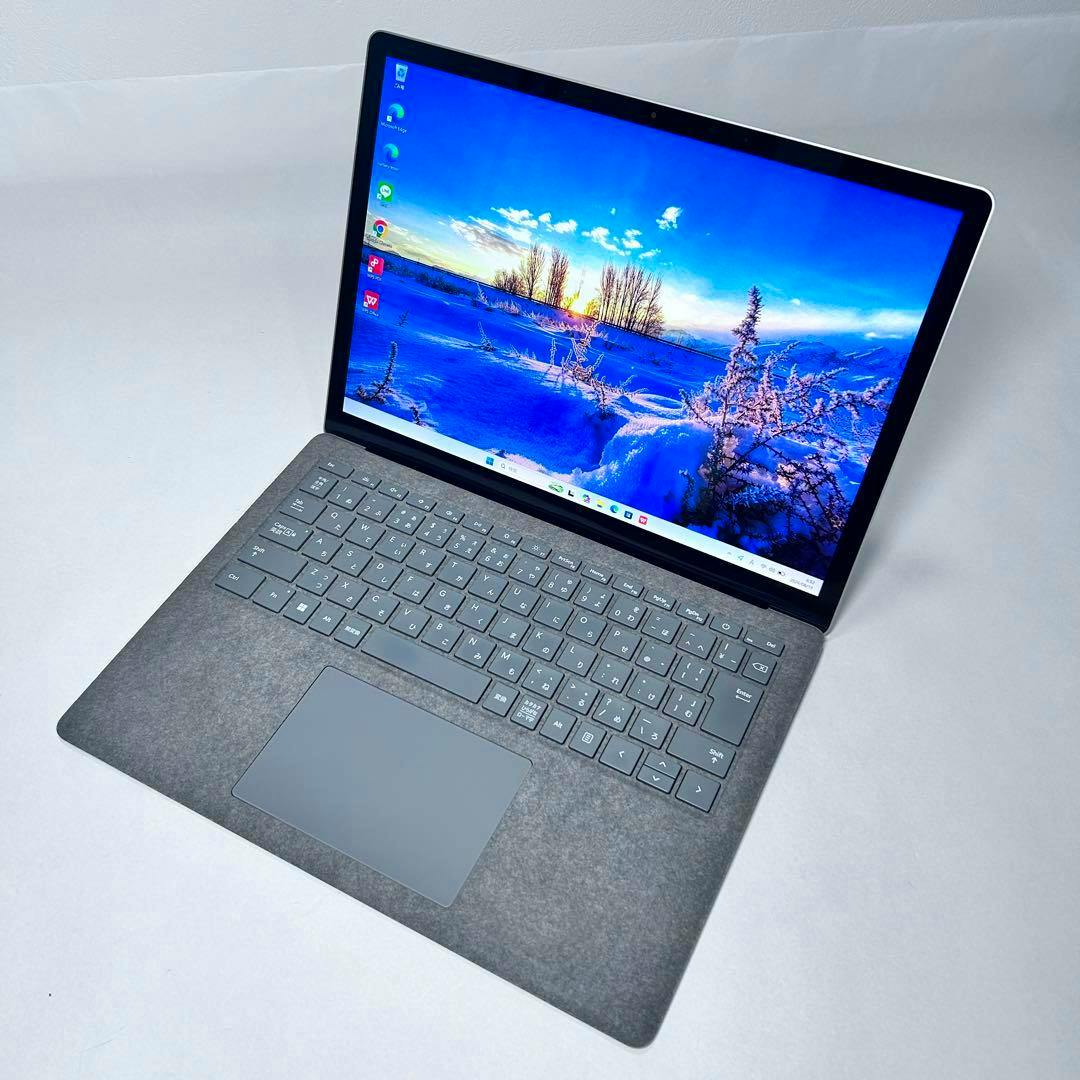 Open Surface Laptop5 showing the keyboard, trackpad, and a display with a snowy landscape wallpaper.