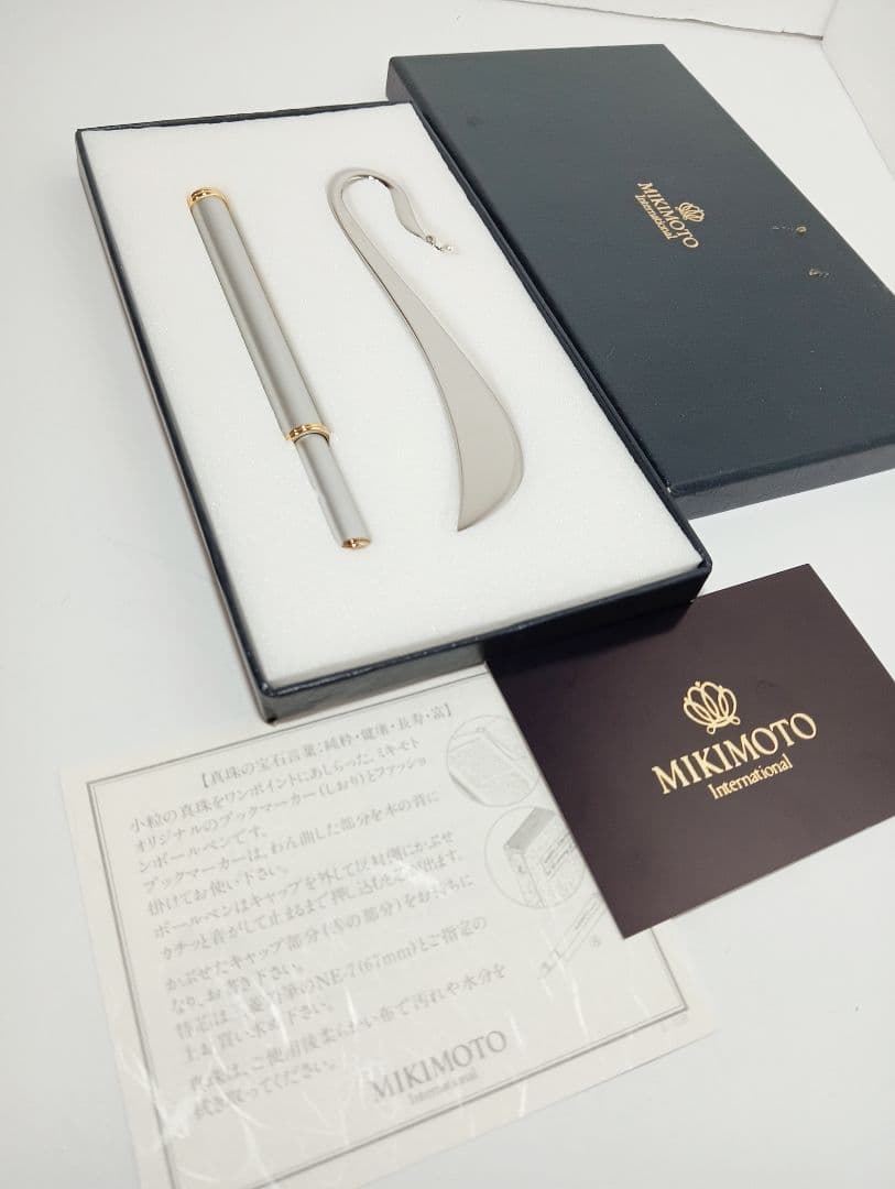 MIKIMOTO metal bookmark and cap-style ballpoint pen set displayed in its presentation box with accompanying paperwork.