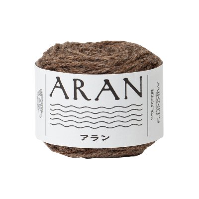 A brown Aran-weight yarn ball with a white label reading "ARAN".