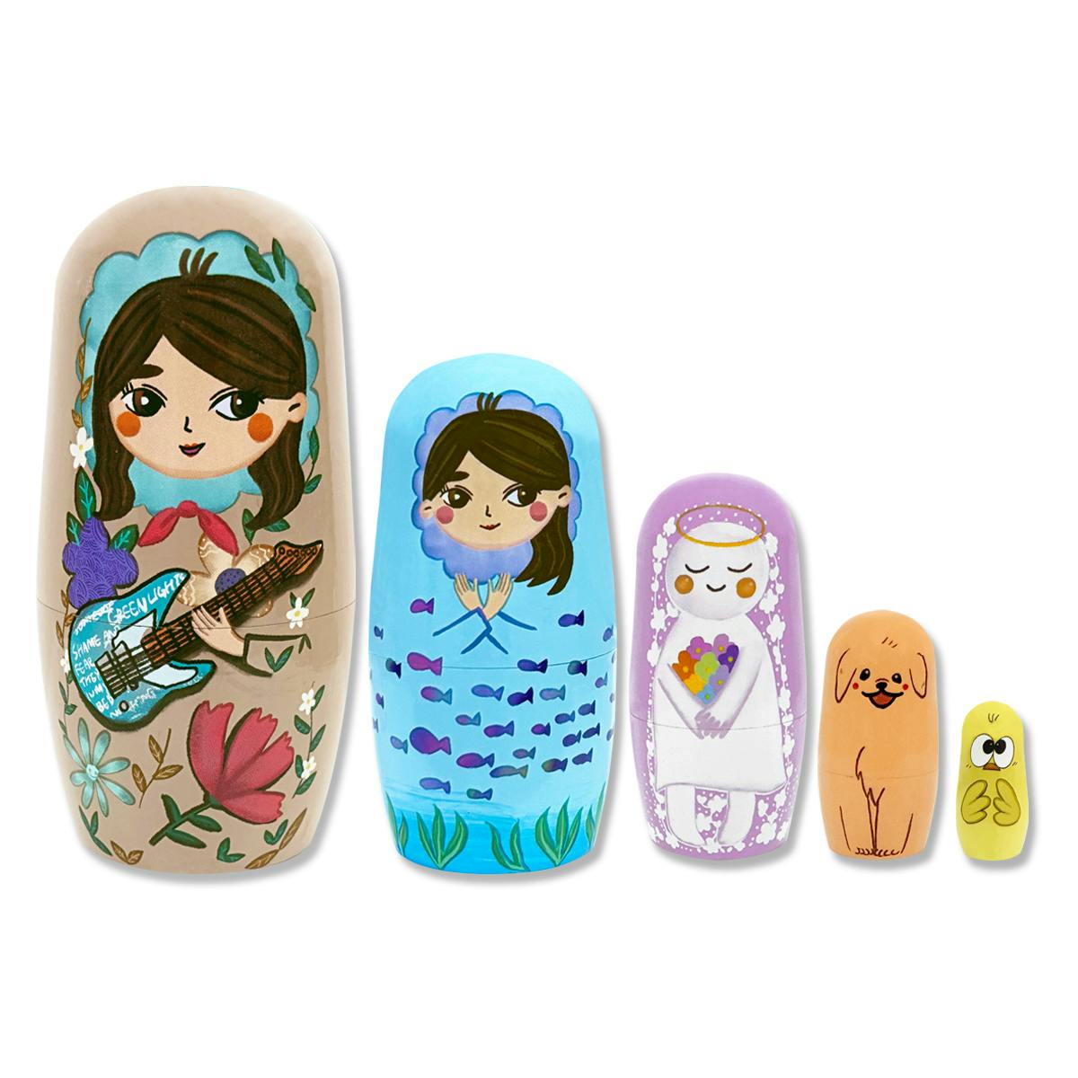 Five painted wooden Matryoshka nesting dolls shown arranged from largest to smallest.