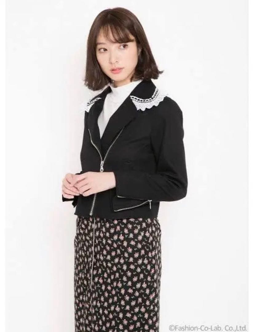 Model wearing the women's black frill riders jacket with a white frill collar.