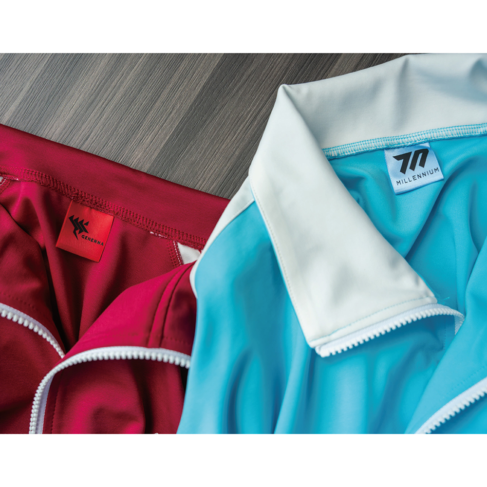 Close-up photo of two polyester jersey jackets showing collars, zippers, and brand labels, one light blue with white collar and one red.