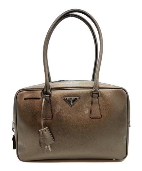 Front view of a mini synthetic-leather boston bag with double top handles and a small triangular logo plaque on the front.