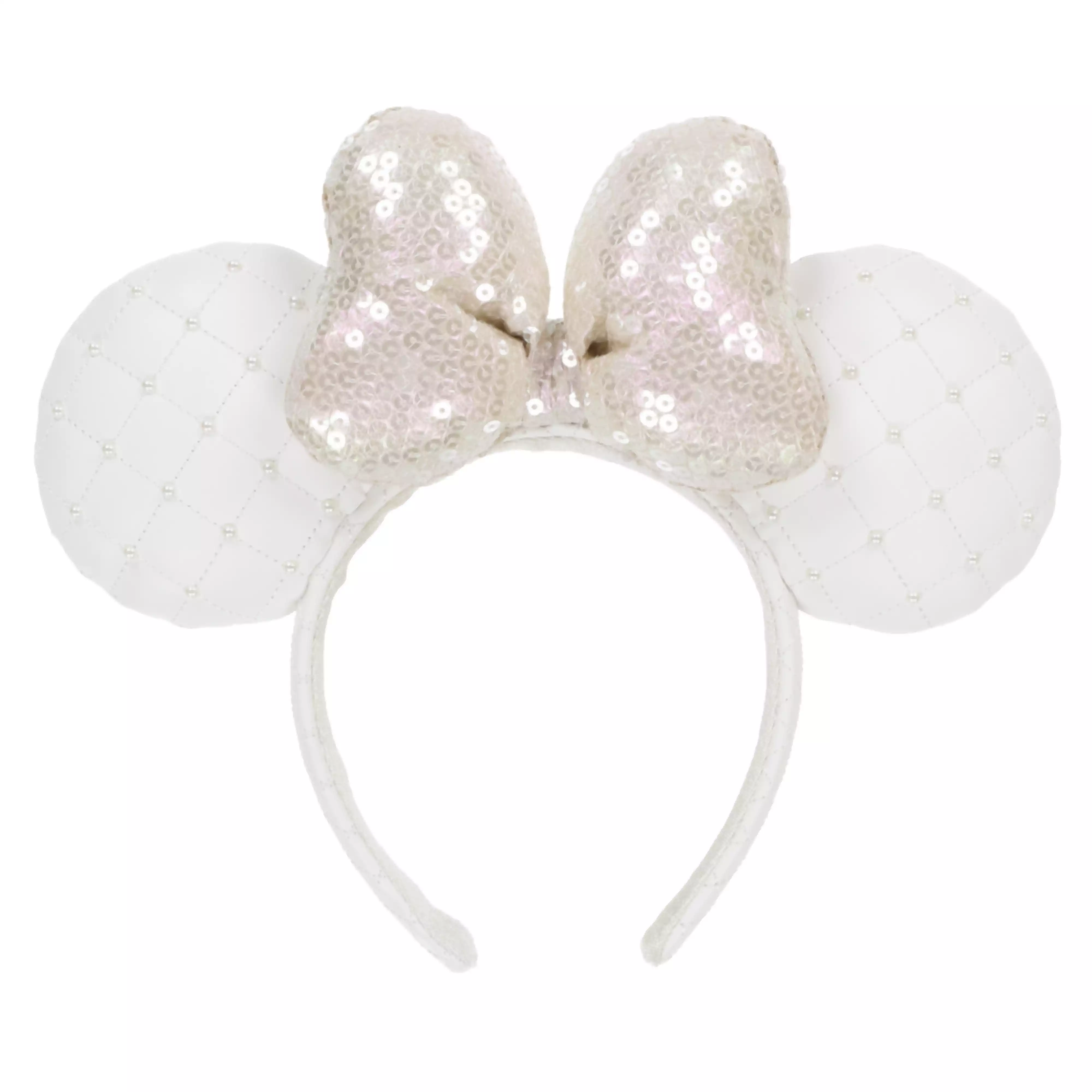 A white headband with quilted round ears and a sequined bow centered on the band.