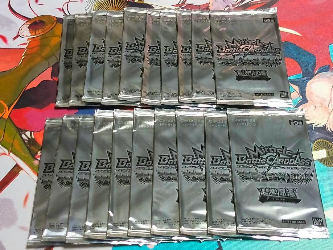 Twenty sealed Miracle Battle Carddass promotional card packs arranged on a colorful playmat.