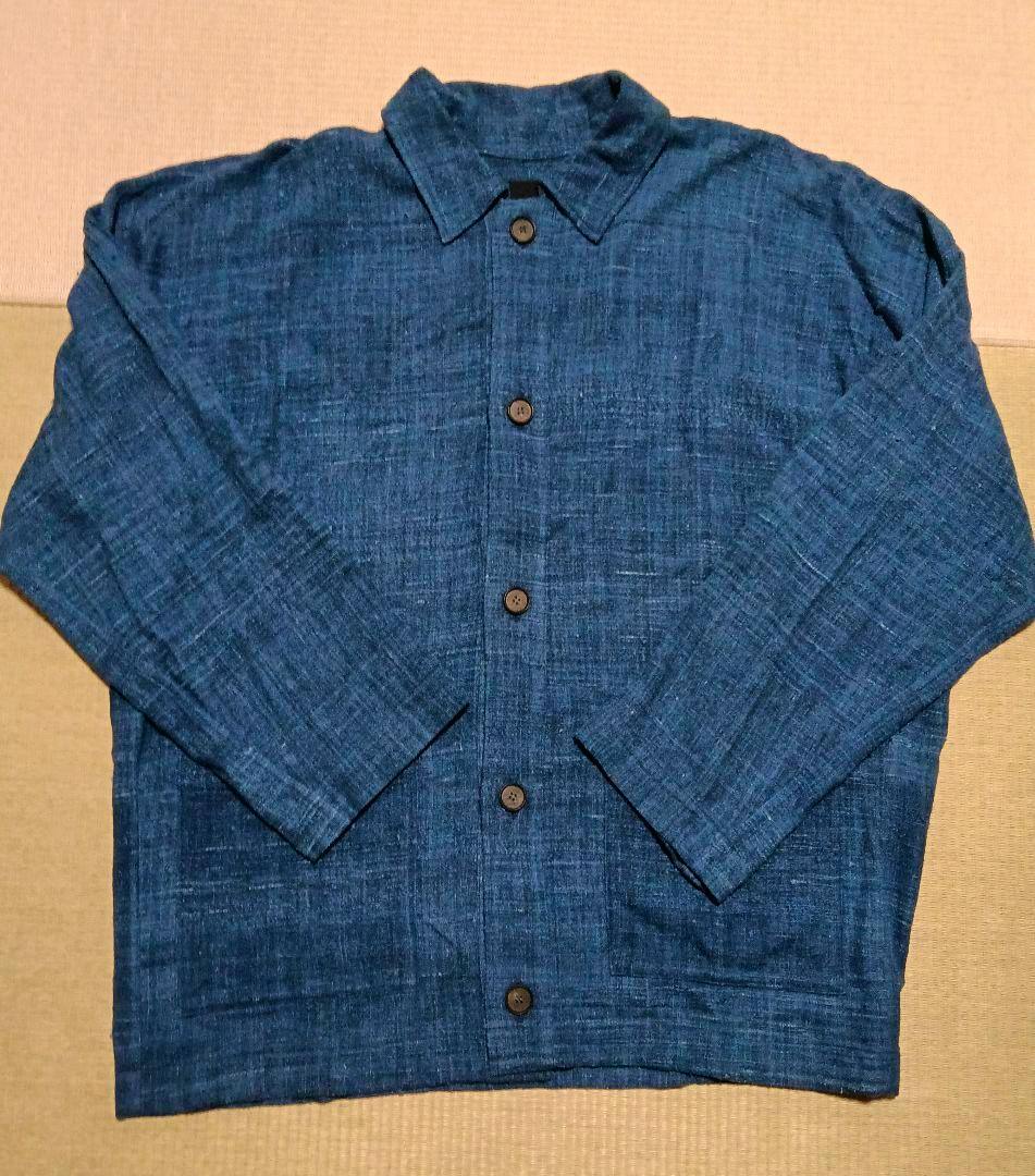 Front view of a blue handwoven silk MITTAN jacket laid flat showing buttons and collar.