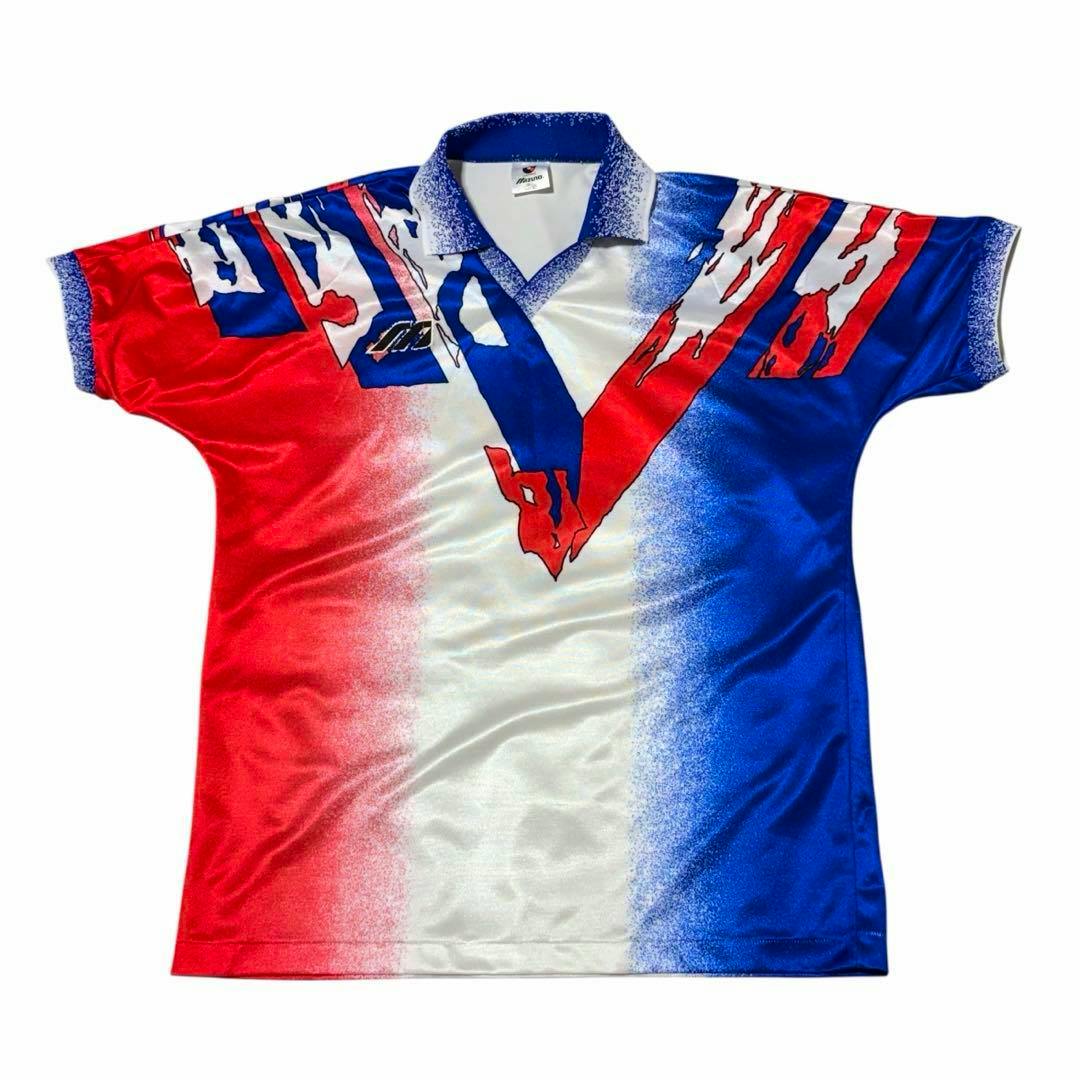 Front of a Mizuno Yokohama Marinos J.League model jersey in red, white, and blue with a V-shaped graphic.