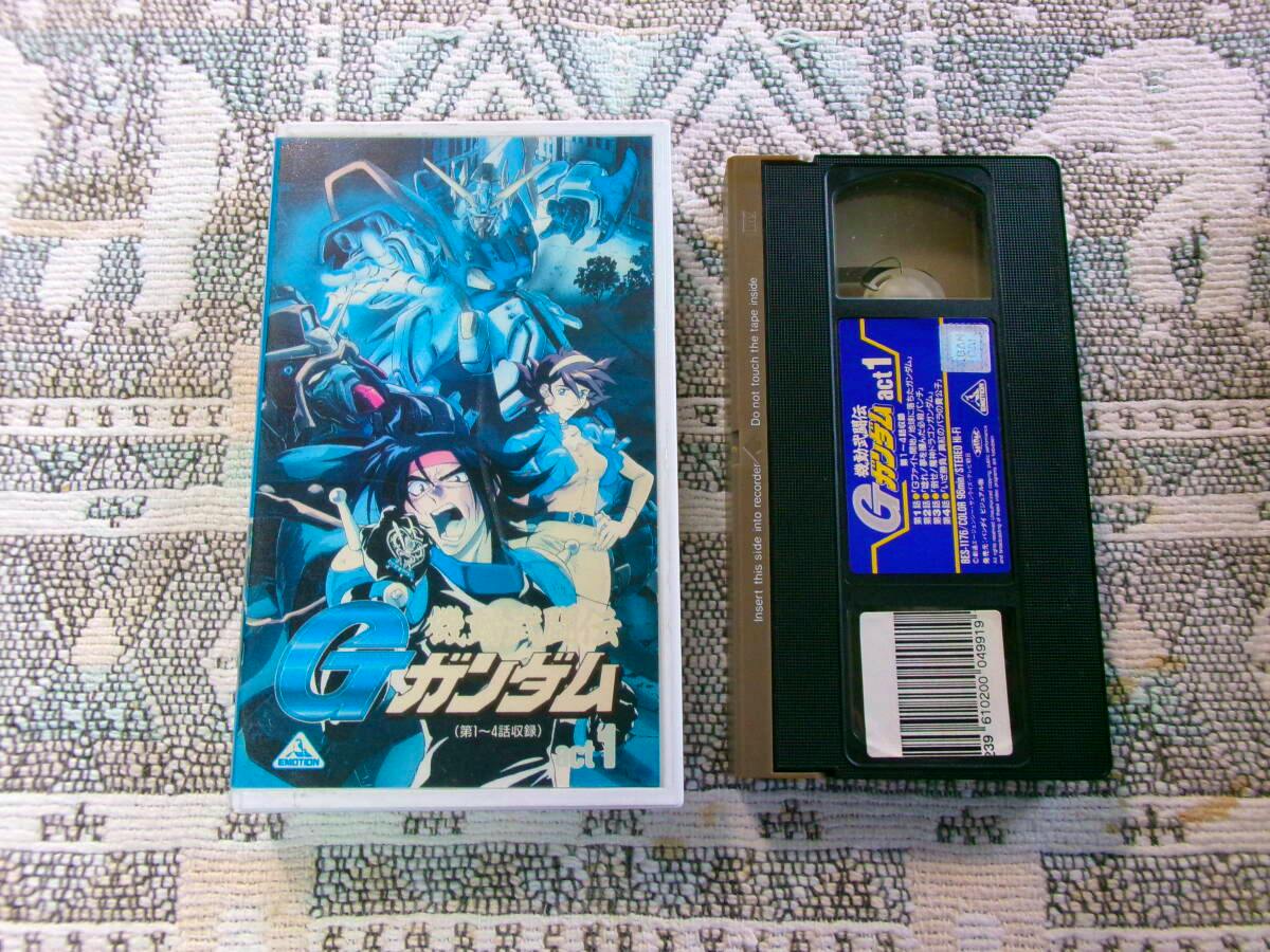 Front cover sleeve and the VHS cassette of the machine‑combat G Gundam (act.1) VHS tape displayed on a patterned fabric background.