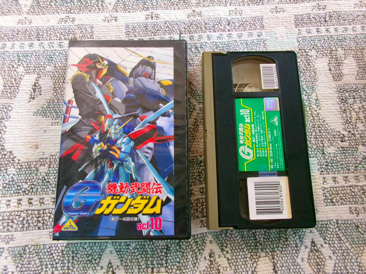 VHS cassette and its illustrated case for G Gundam act.10 shown side by side on a patterned surface.