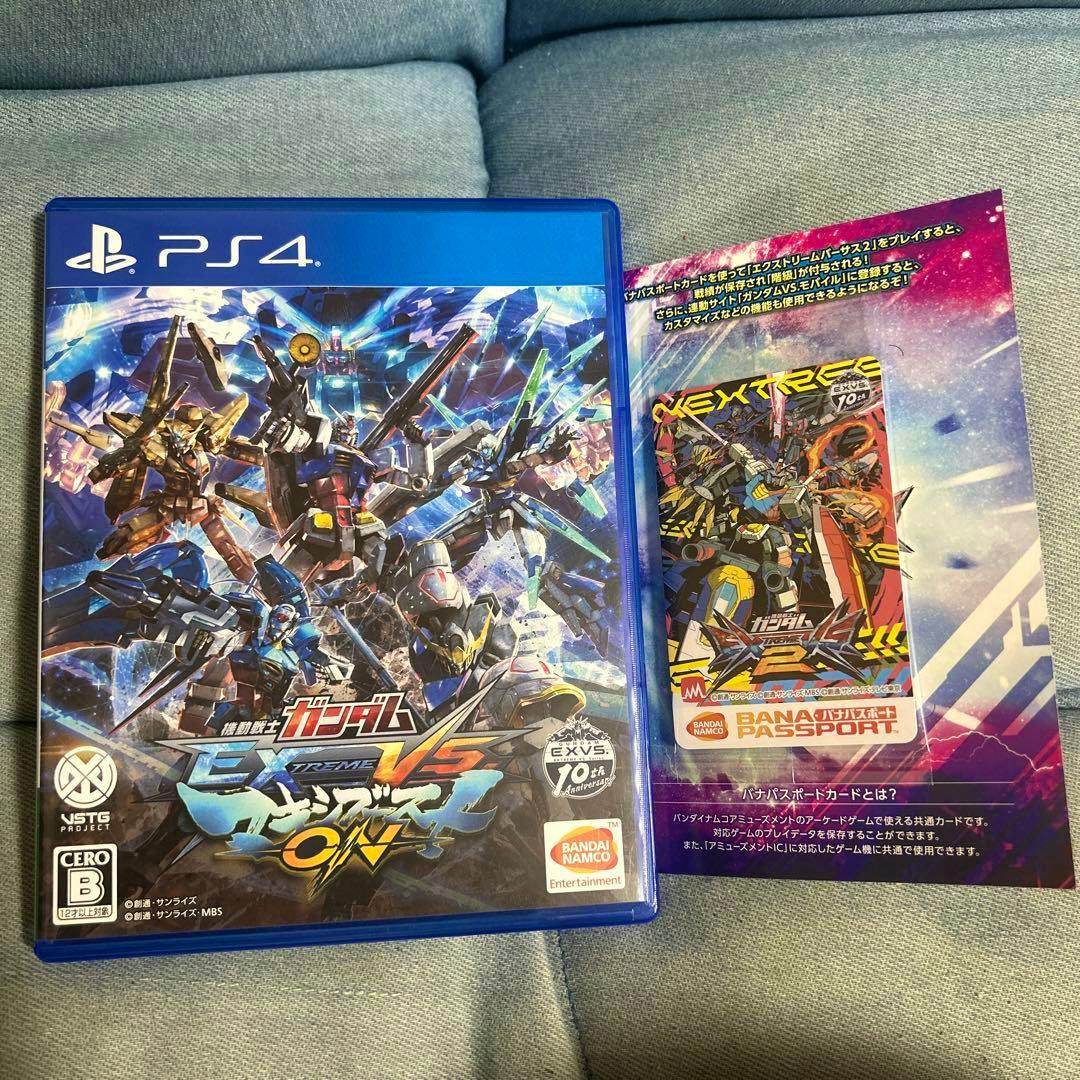 Front cover of the PS4 game case for 機動戦士ガンダム EXTREME VS. マキシブーストON shown next to a Bandai passport card.