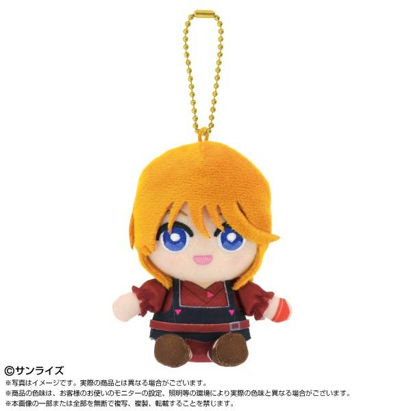 Chibi plush sitting mascot keychain of Elpeo Ple from Mobile Suit Gundam ZZ with orange hair, blue eyes, and a gold bead chain on a white background.