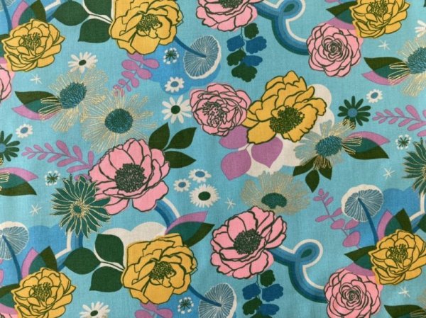 Light blue cotton fabric with pink and yellow floral print and green leaves.