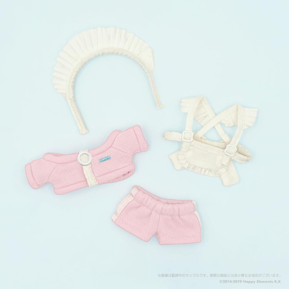 Flat lay of the doll jersey maid outfit showing a headband, pink top, white apron with straps, and pink shorts.