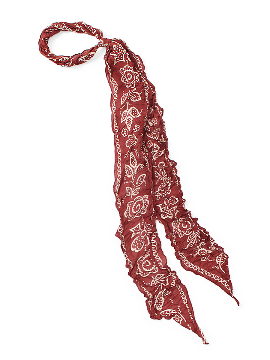 Red patterned scarf with white floral bandana-style print displayed on a white background.