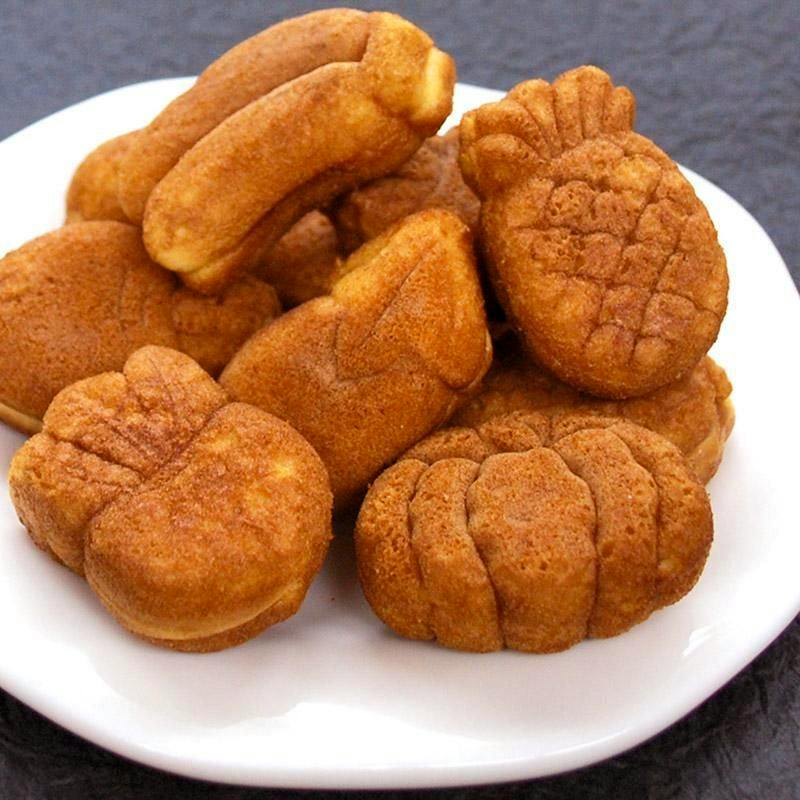 Several small molded cakes arranged on a white plate.