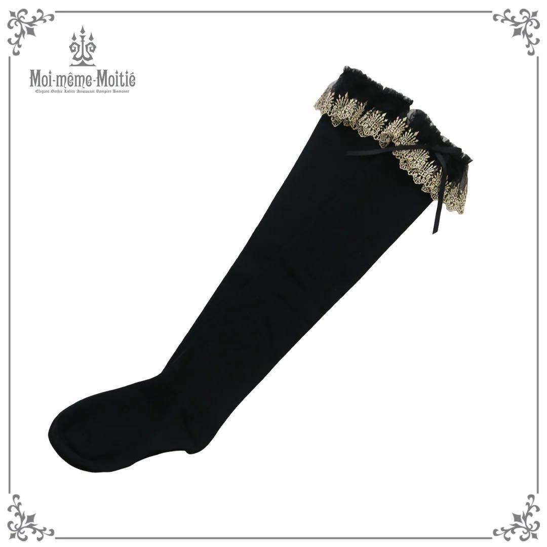 Black women's over-knee sock with gold crown lace trim and a small ribbon bow shown on a white background.