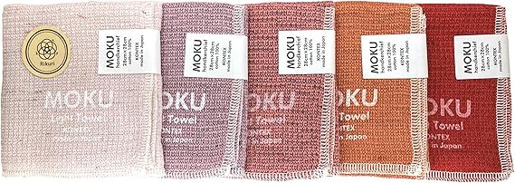 Set of five folded MOKU hand towels in gradient sunset colors with visible MOKU labels.