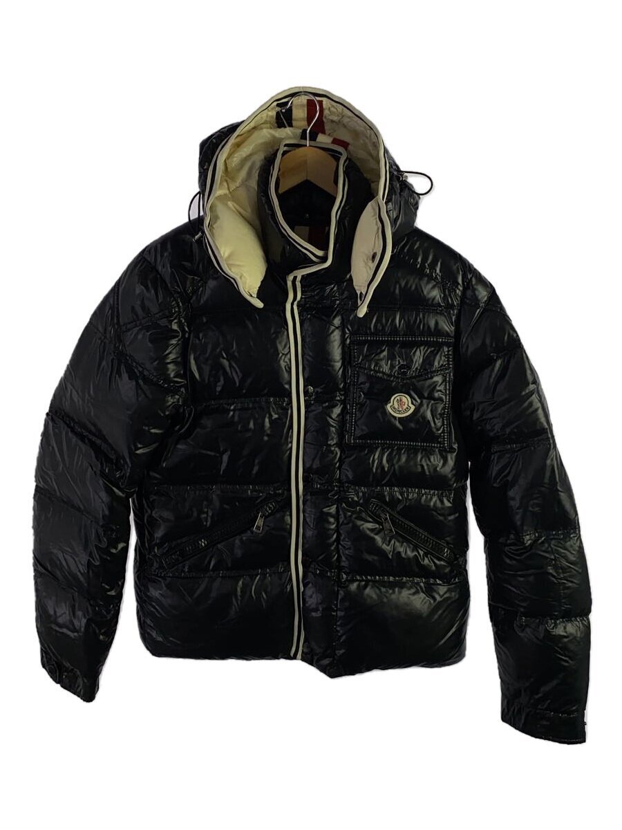 Front view of the black MONCLER Branson down jacket with hood and visible Moncler chest patch hanging on a hanger.