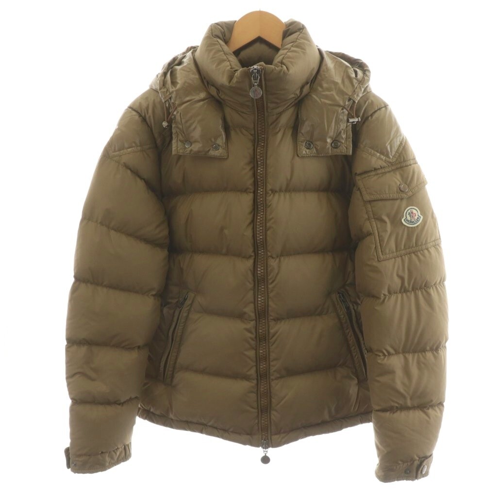 Front view of a beige Moncler Chevalier men's nylon down jacket with hood hanging on a hanger.