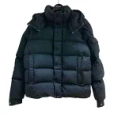 Front view of a men's Moncler polyester padded jacket hanging on a hanger against a white background.