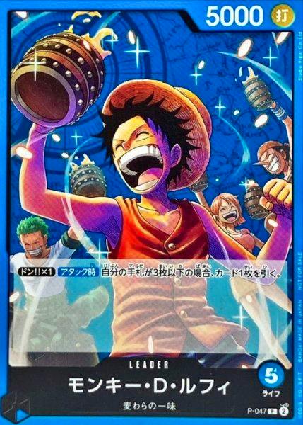 Photograph of a Monkey D. Luffy trading card showing Luffy raising a barrel with other characters in the background, Japanese text, and card stats.
