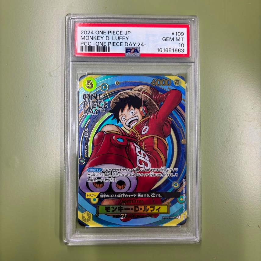 Front of the Monkey D. Luffy SR trading card in a PSA graded slab, showing the card art and the PSA label indicating GEM MT 10.