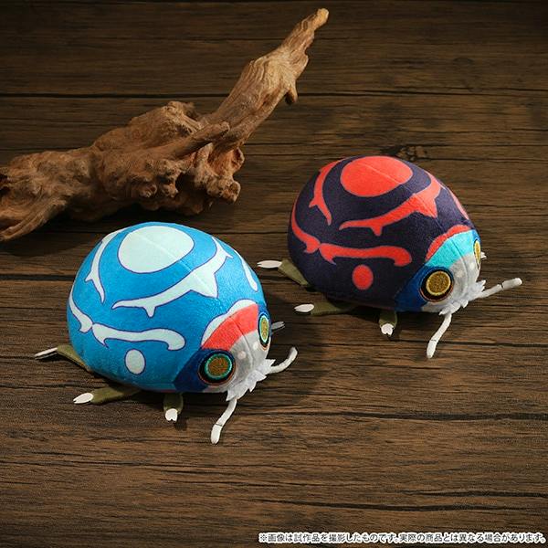 Photograph of two Mononoke theatrical film ladybug plush mascots (blue and navy variants) displayed on a wood surface.
