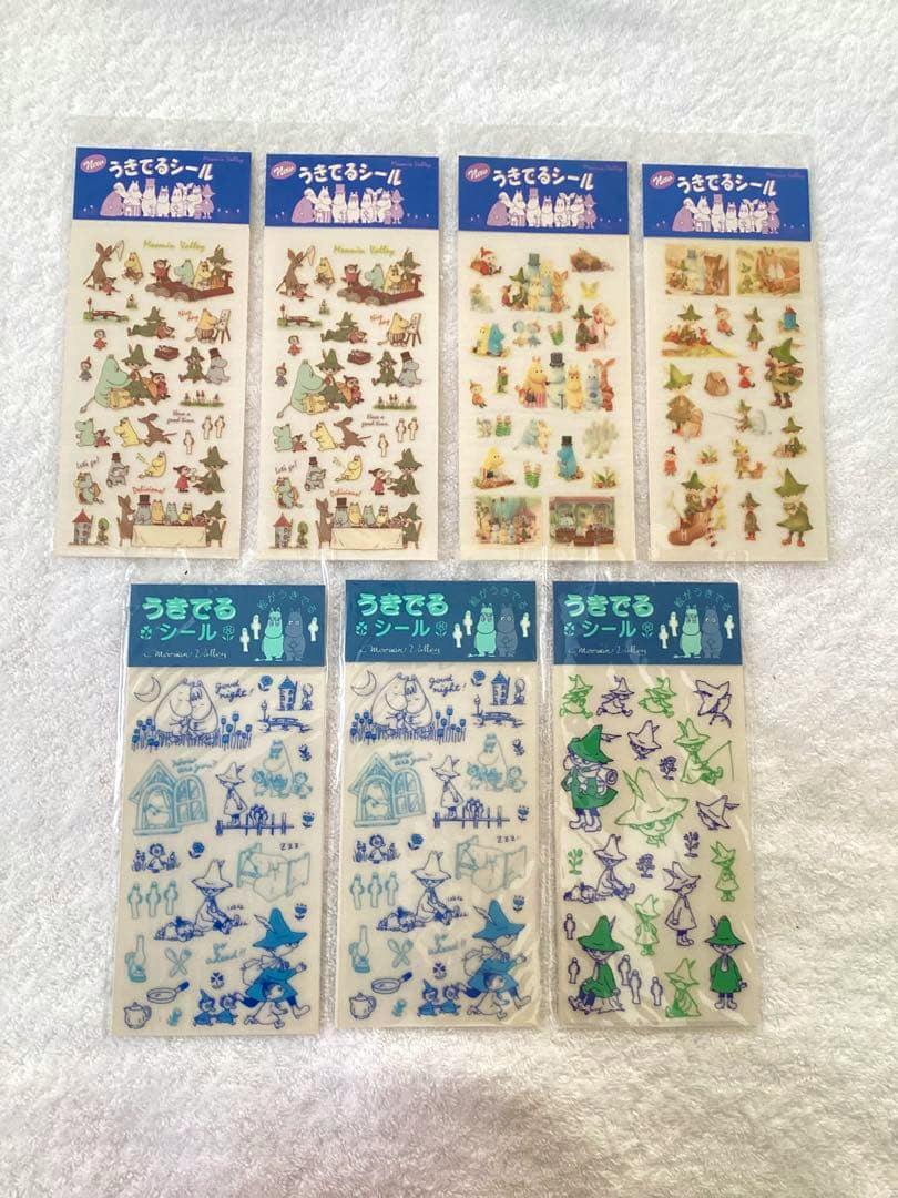 Eight Moomin retro sticker sheets shown front-side arranged on a white textured surface.
