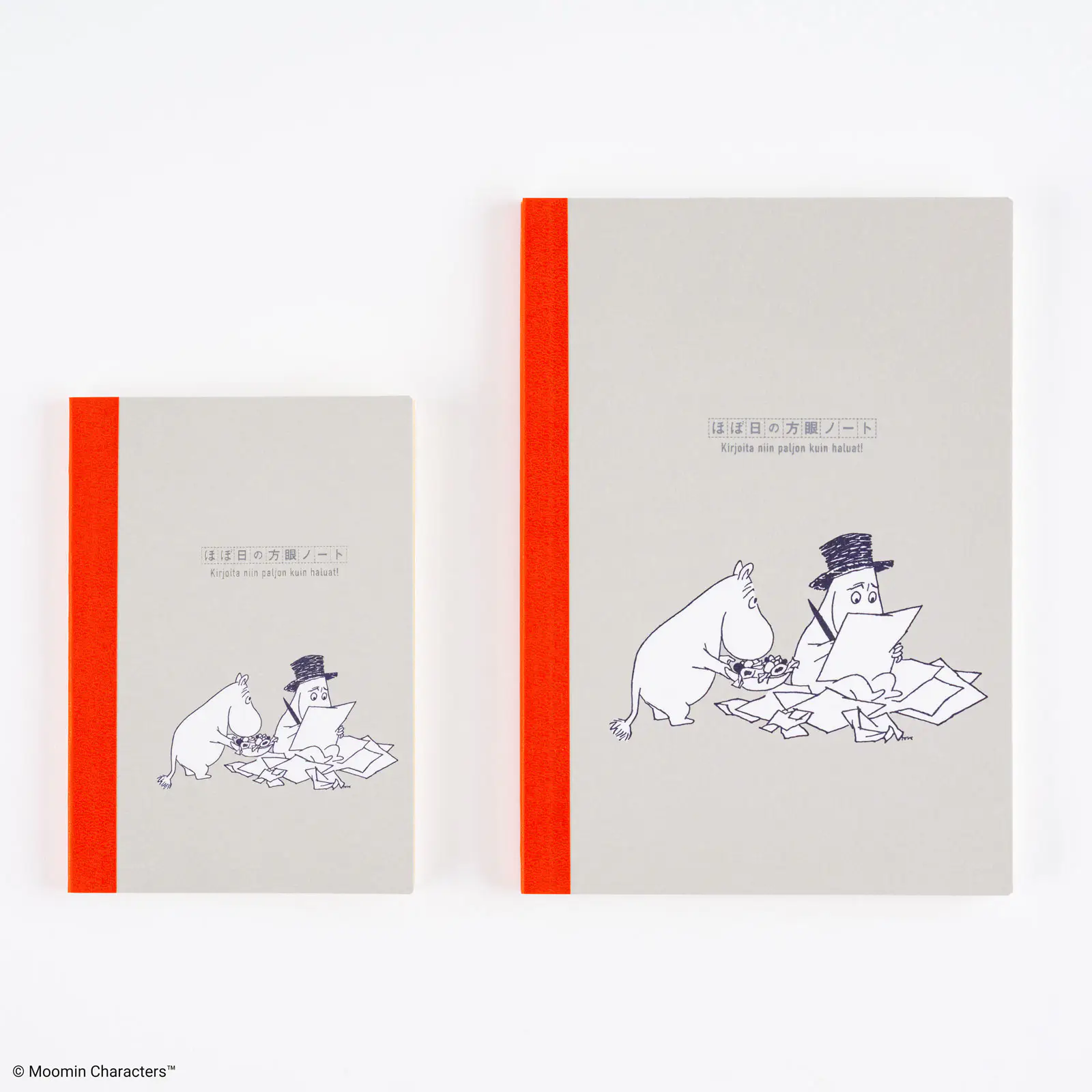 Two gray Moomin Hobonichi graph notebooks with an orange spine and a black line illustration of Moomin characters on the cover, shown in small and large sizes.
