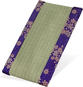 Mini tatami mat with a green woven surface and purple floral fabric borders, shown angled on a white background.