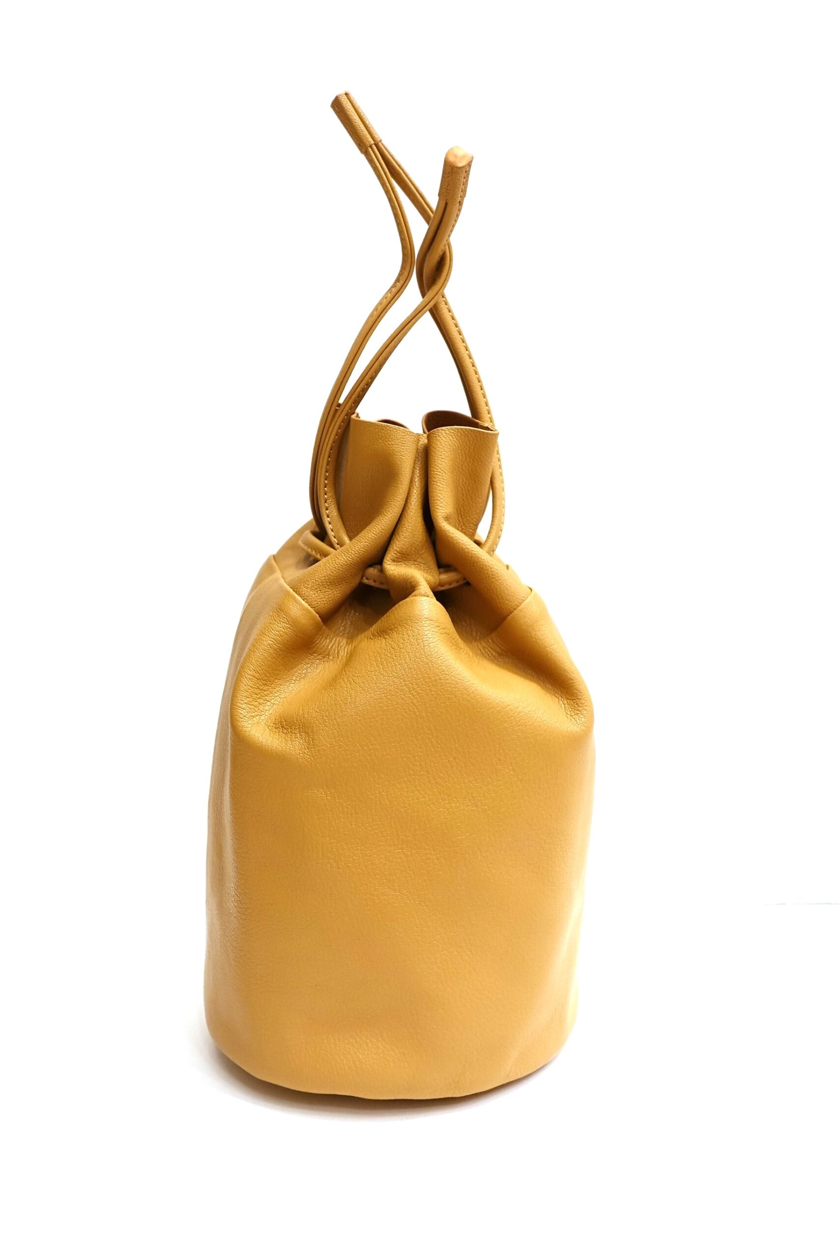 Natural-colored goat leather drawstring pouch bag photographed on a white background.