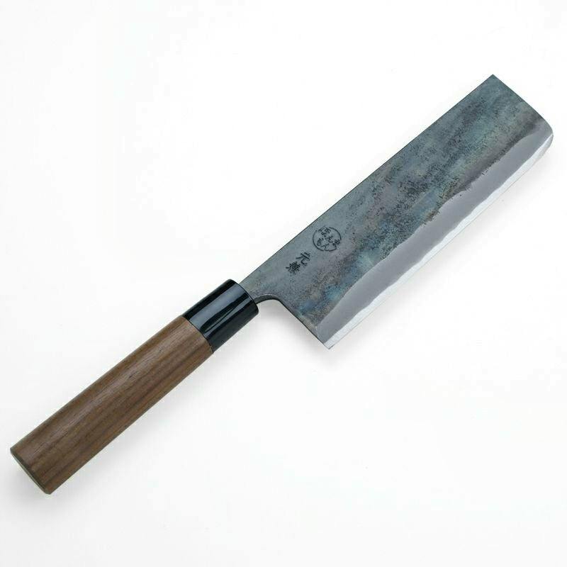 Top-down photo of a nakiri (vegetable) chef knife with a dark forged blade and a walnut handle.