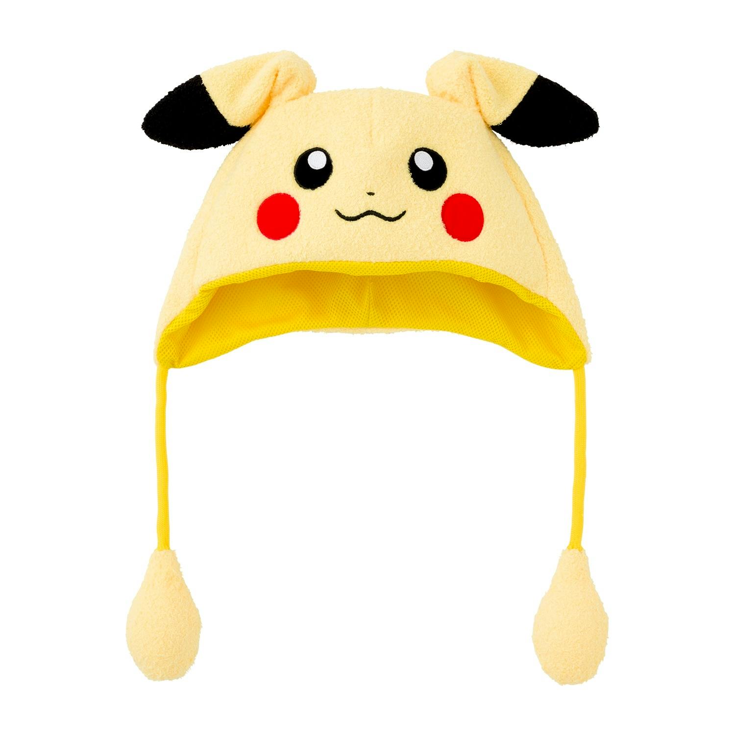 Front view of a yellow children’s hat with a smiling character face, black-tipped ears, and two hanging pom-pom tassels.