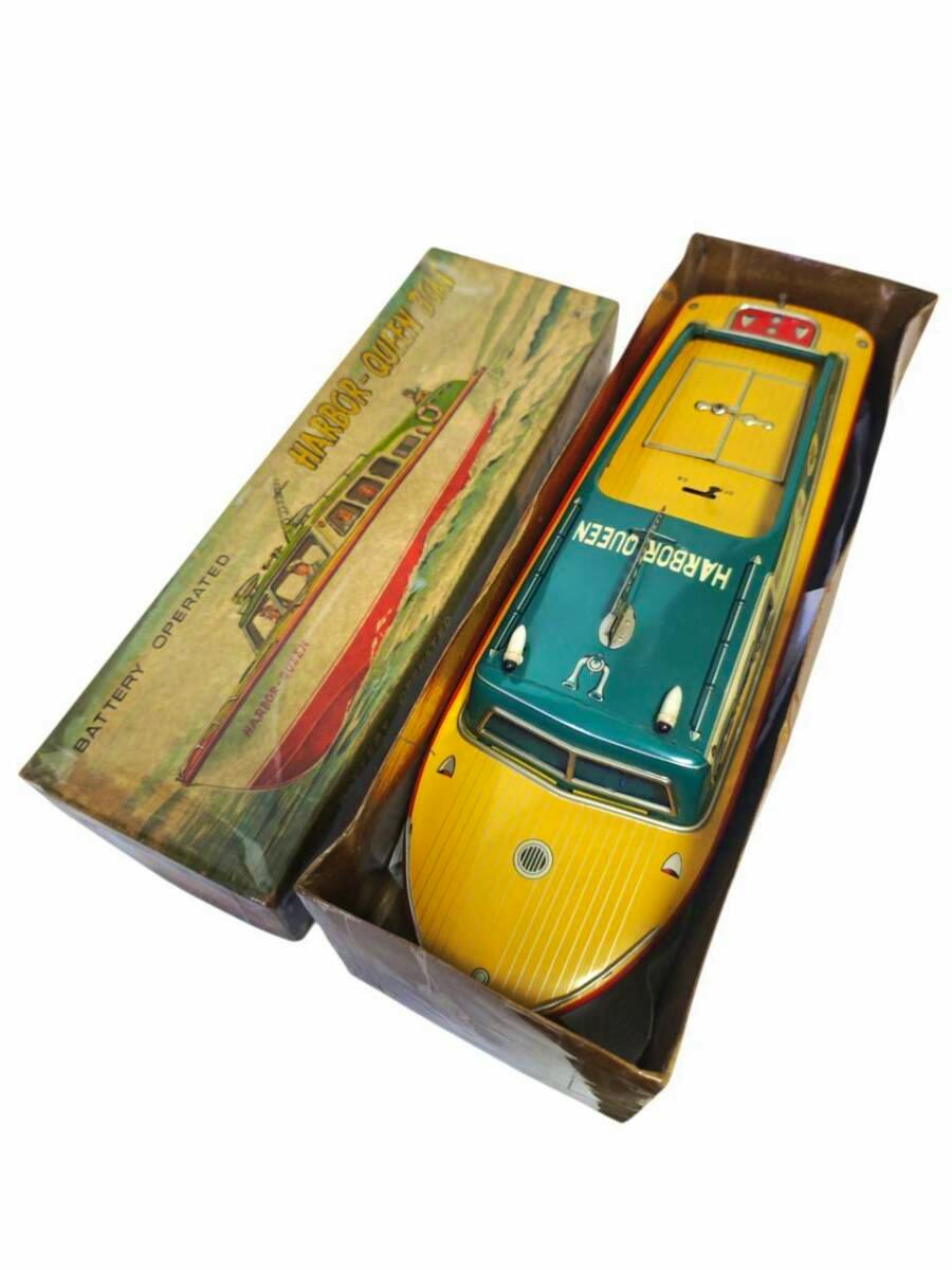 Tin metal Harbour Queen toy boat shown in its box from an angled top view.